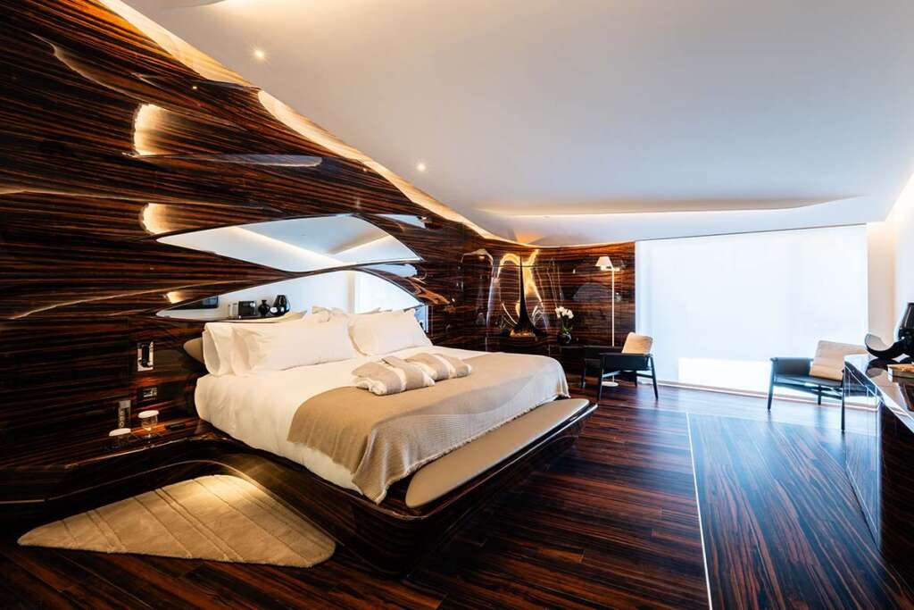 Sculptural interior of Hotel Romeo Roma with flowing ebony curves designed by Zaha Hadid Architects