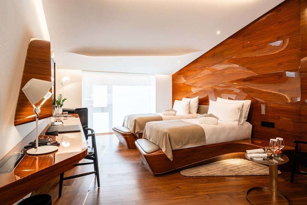 Sculptural interior of Hotel Romeo Roma with flowing ebony curves designed by Zaha Hadid Architects