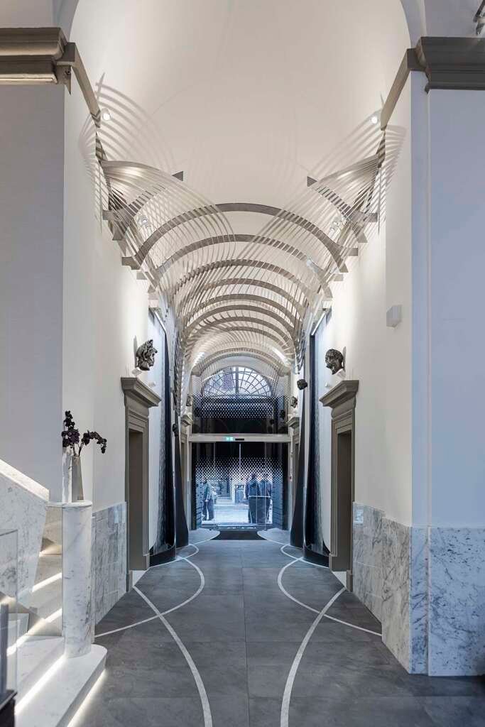 Sculptural interior of Hotel Romeo Roma with flowing ebony curves designed by Zaha Hadid Architects