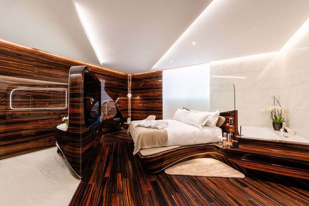 Sculptural interior of the rooms at the Hotel Romeo Roma with flowing ebony curves designed by Zaha Hadid Architects