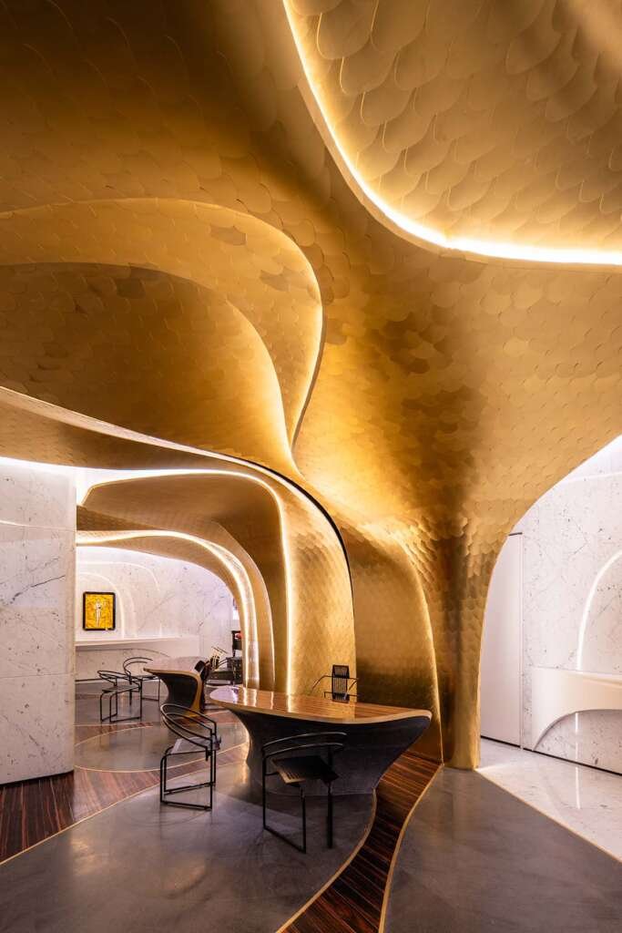 Sculptural interior of Hotel Romeo Roma with flowing ebony curves designed by Zaha Hadid Architects