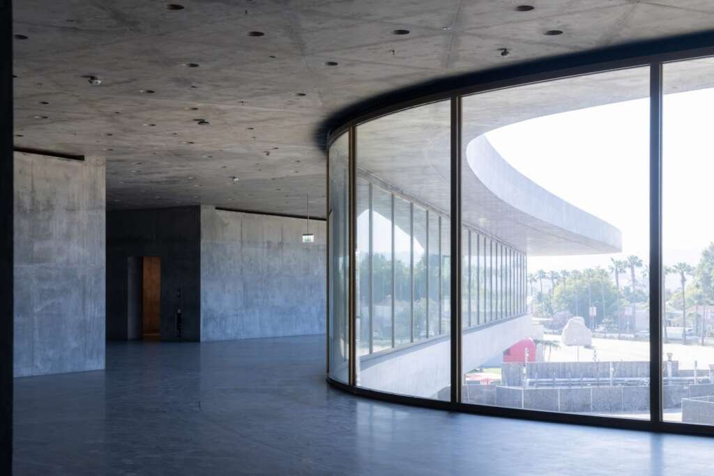 Interior gallery space with natural light flooding through glass walls at LACMA designed by Peter Zumthor