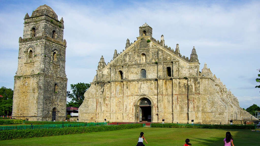 View of Paoay Church in the Philippines with thick walls and low profile typical of Earthquake Baroque style.
