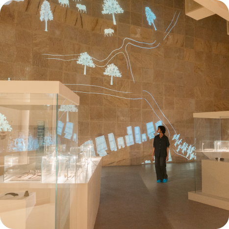 Artifacts from the Mauryan period with digital annotations and multimedia explanations at Vadnagar Museum.