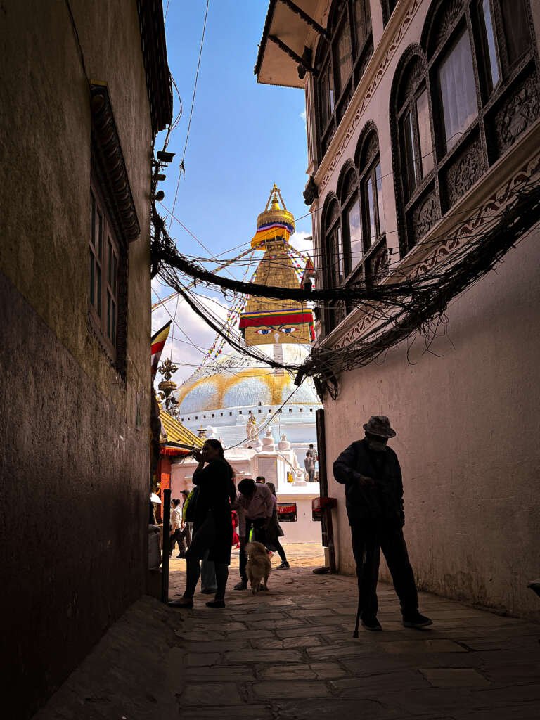 view of a temple pagoda between two buildings from a street 