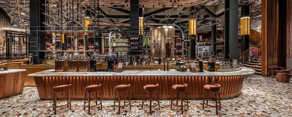 Starbucks Milan with marble counters, olive wood panels, and floor-to-ceiling windows