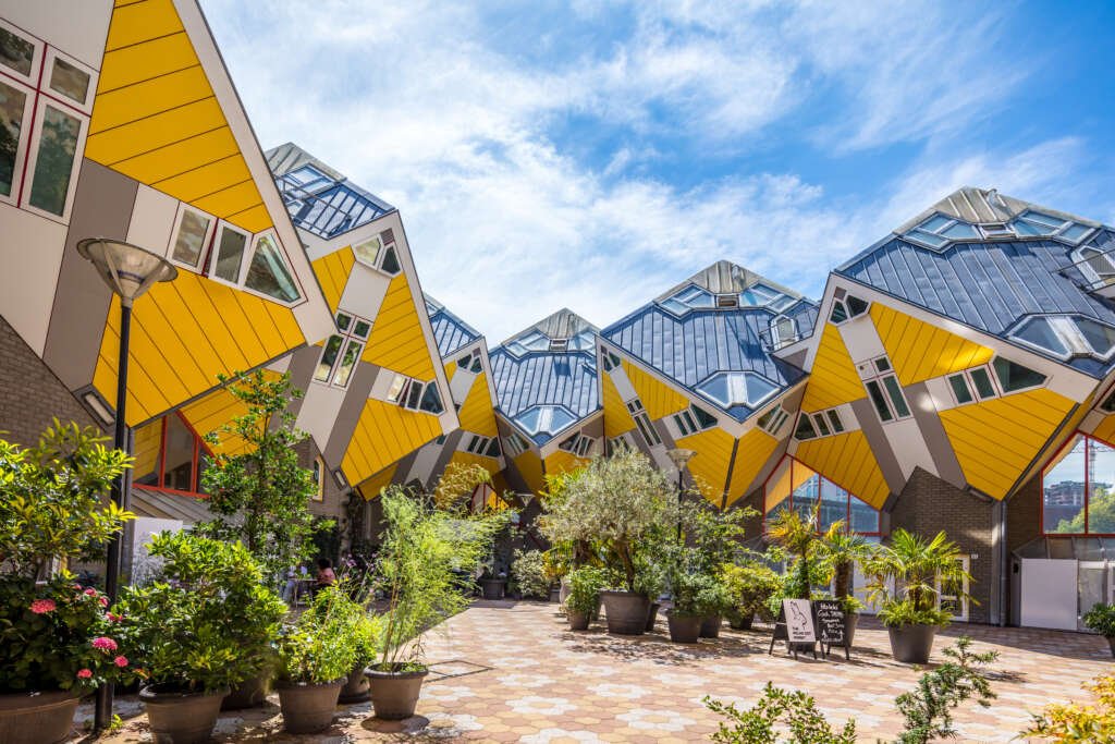 Cube houses in Rotterdam designed by Piet Blom, featuring innovative, sustainable design with energy-efficient heating systems and water conservation features