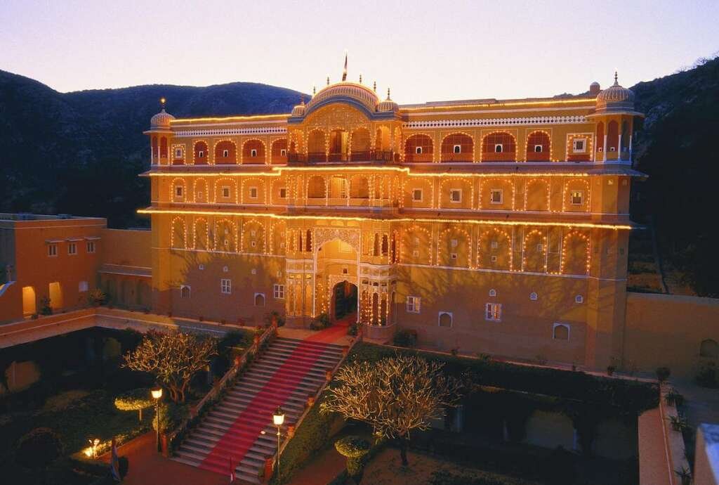 Intricate Mughal-Rajput architecture of Samode Palace, with hand-painted frescoes, archways, and ornate mirrorwork halls.