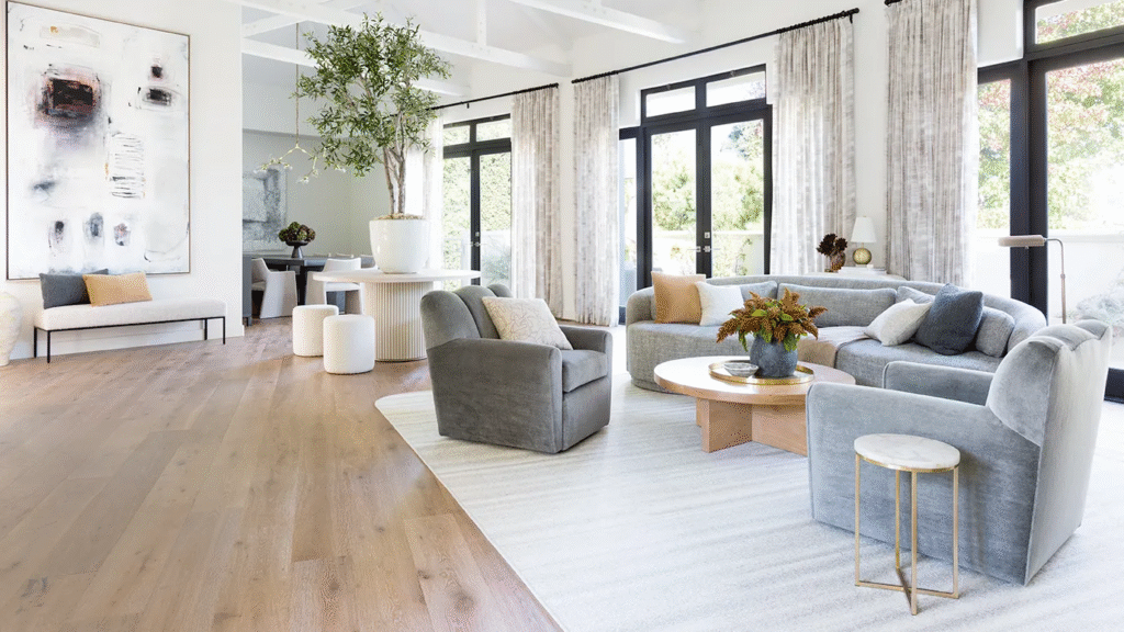 A spacious living room designed with minimal ornamentation, featuring a cohesive color palette and a focus on intentional furniture placement for a calming, curated atmosphere.