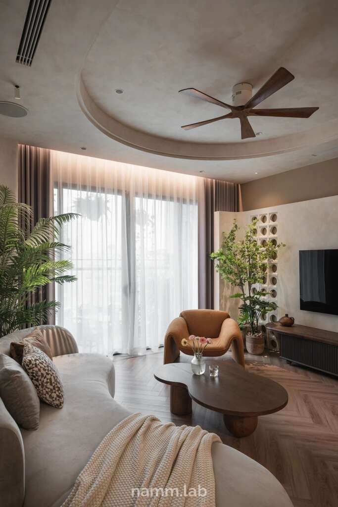 neutral coloured living room with curves used in ceiling and furniture