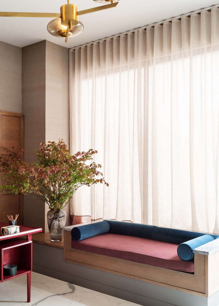 Wooden bench next to window in a living room interior design