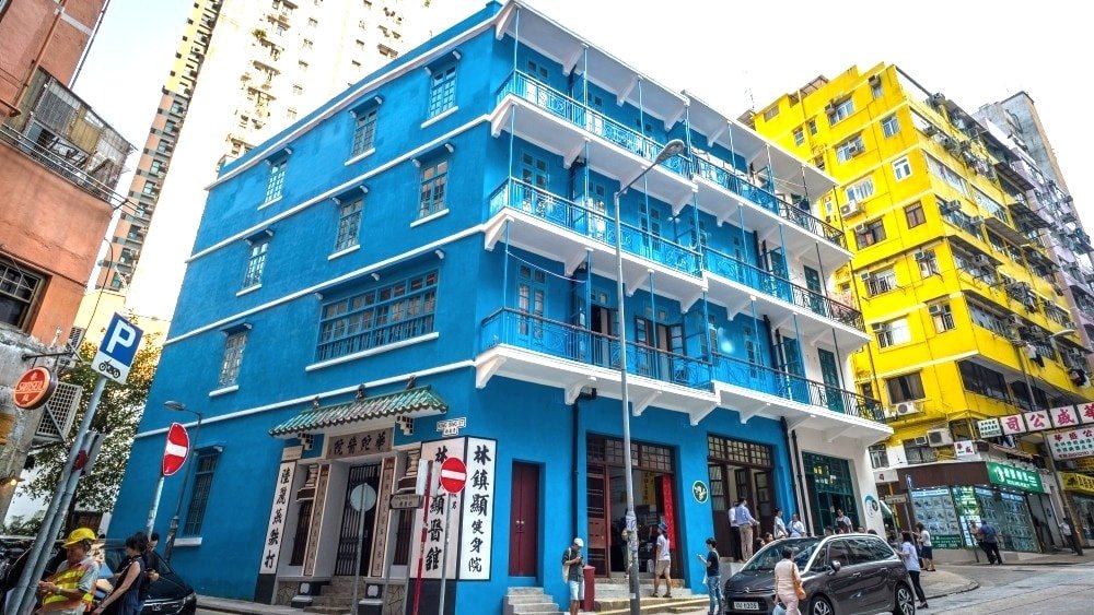 street view of a blue tenement structure in Hong Kong