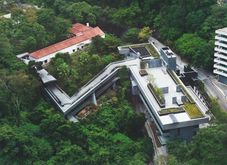 aerial view showing zig-zag bridge of Asia Society Hong Kong Centre in a lush green landscape