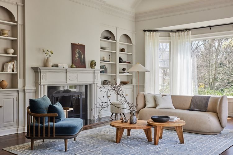 A bright and airy living room featuring a neutral color palette with soft beige walls and white trim.