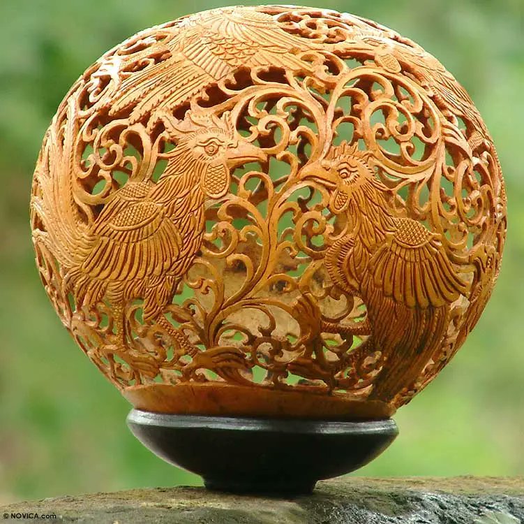 carved spherical brown object on a stone surface