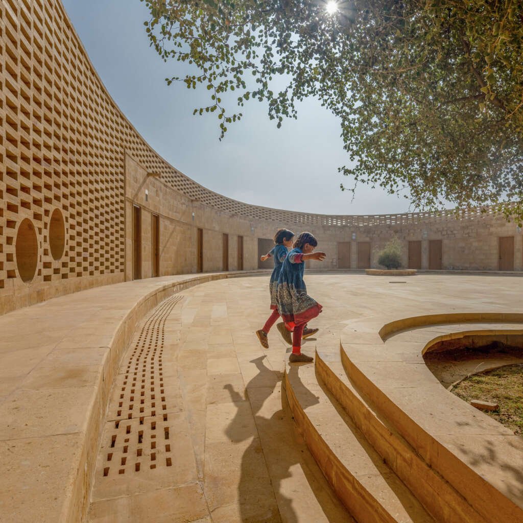 girls playing on the steps in a courtyard