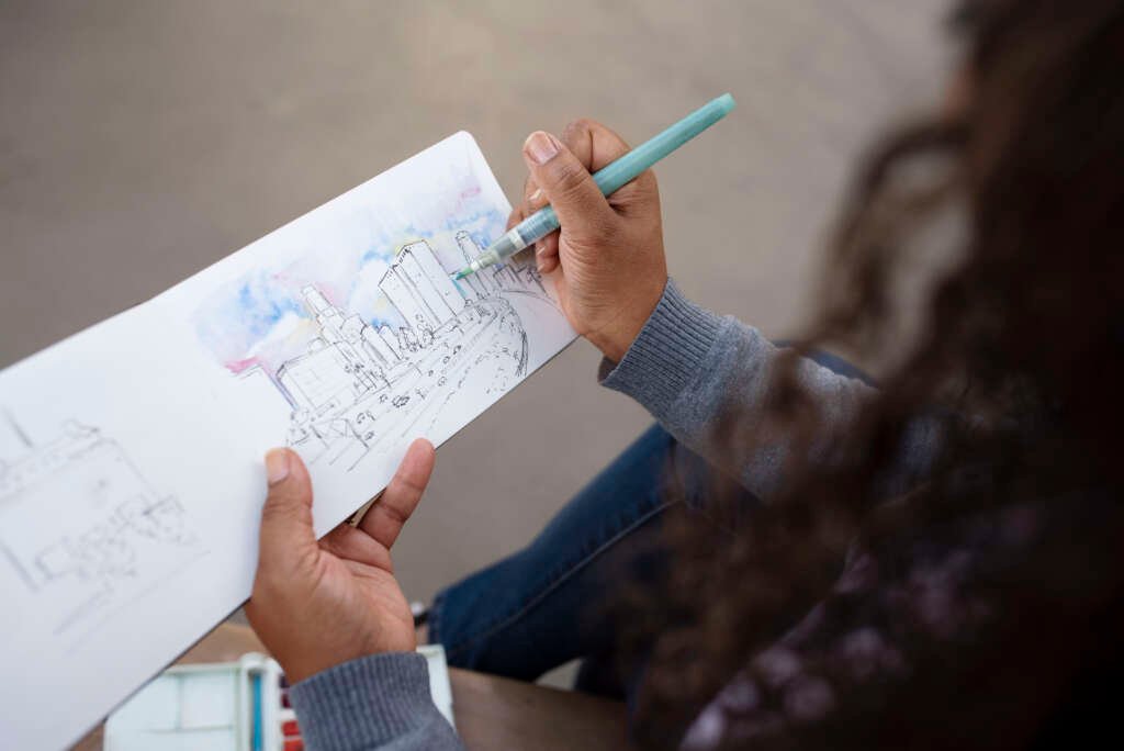 Woman drawing the cityscape in her sketchbook