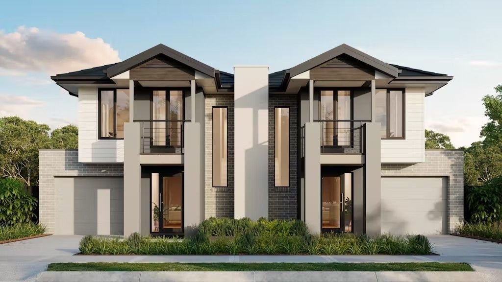 A modern two-story duplex with symmetrical architecture, featuring sleek glass balconies, grey brick accents, white panel cladding, landscaped front garden, and dual garages.