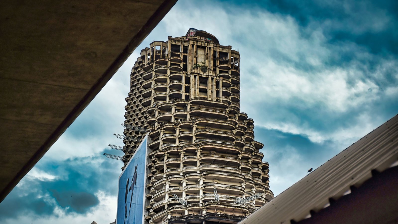 view of the abandoned sathorn tower rising against a colourful sky