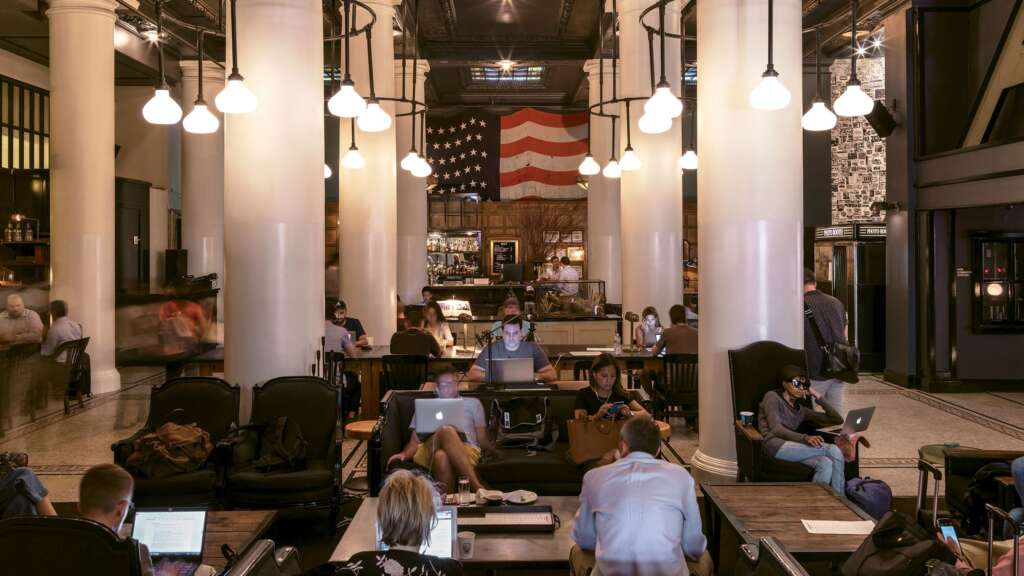 Hospitality Design For The Community: How Architects Are Rethinking What It Means To Host 3 hybrid hospitality space where a hotel lobby functions as both a co-working area.