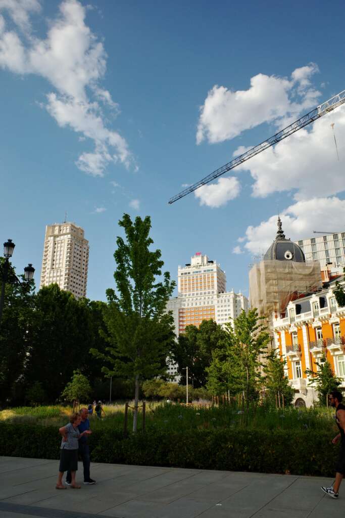 neighbourhood of buildings with people strolling around