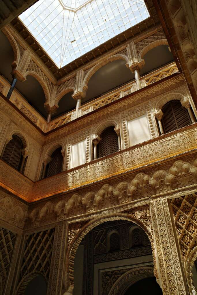 courtyard of a classical building lit by natural sunlight through its roof