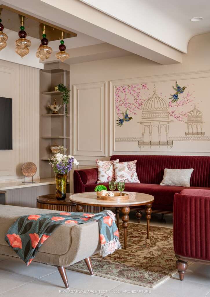 Top 10 (Fresh) Living Room Design Ideas For 2025 1 indian living room with heritage art on wall & maroon luxury sofa with wooden tables