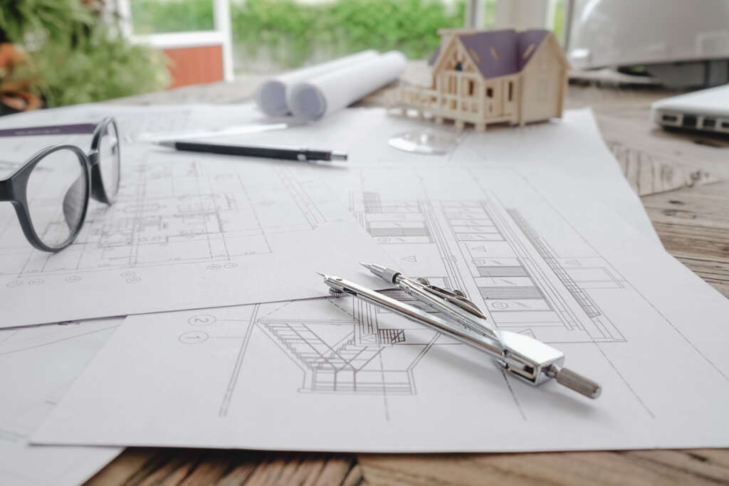 The Truth About Working In Big Vs. Small Architecture Firms 1 image of engineering objects on workplace top view.construction concept. engineering tools.vintage tone retro filter effect,soft focus(selective focus)