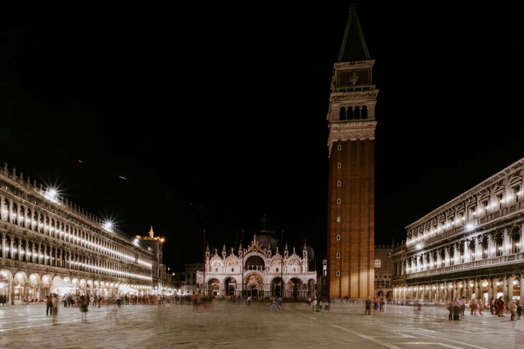 Night view of St. Mark’s Square in Venice with St. Mark’s Basilica and the Campanile illuminated.