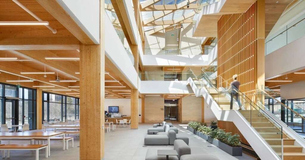contemporary mass timber office interior featuring exposed wood beams, natural daylight, and warm architectural detailing.