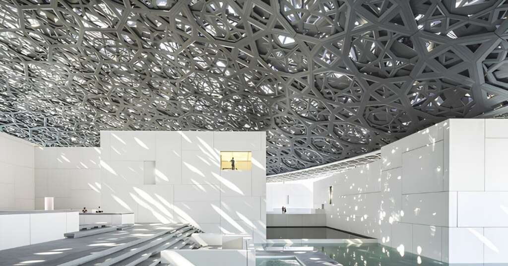 Louvre Abu Dhabi Architecture: How Light, Shadow And Culture Come Together 3 close-up view of louvre abu dhabi's geometric dome structure showcasing intricate engineering and filtered daylight.